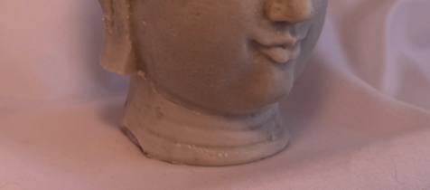 bas d'un visage de bouddha en cire