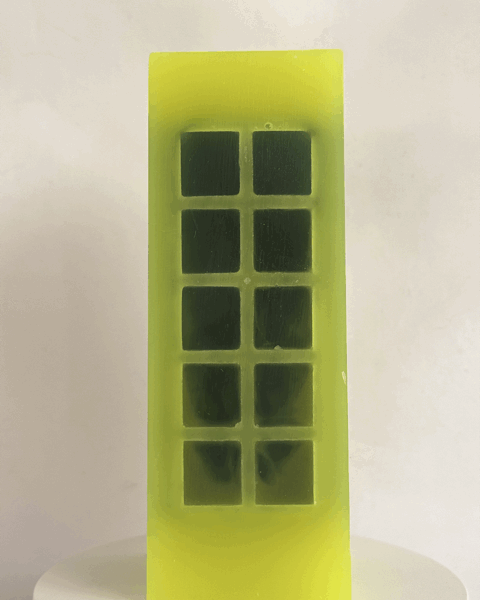 Bougie jaune citron fluo avec incrustations vert foncé