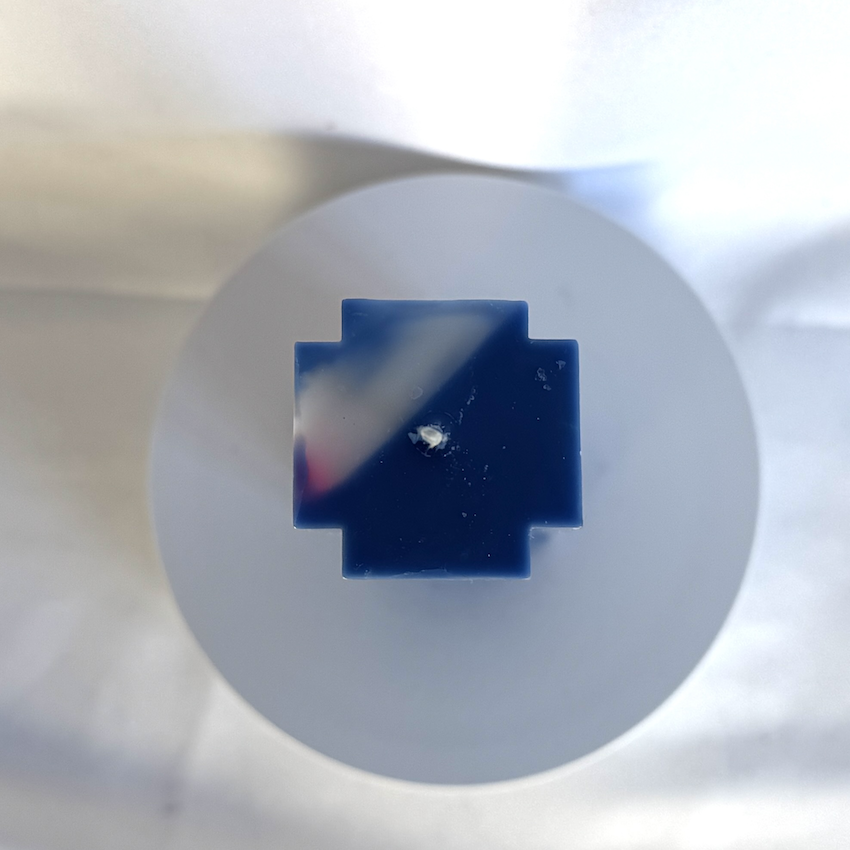 Bougie bleue en forme de croix, avec inclusion rose fluo et blanc