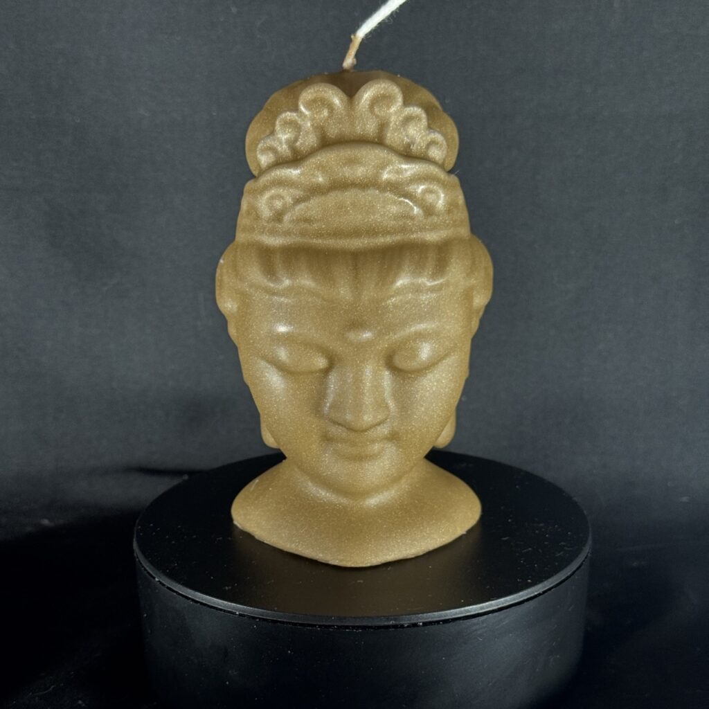 Bougie visage féminin dorée — collection Champagne doré, cire végétale et minérale, finition satinée.