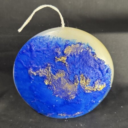 Bougie disque 14 cm de la collection Nuit Étoilée, en cire minérale et végétale blanche, avec finition bleu outremer et dorures à la main. Création artisanale boo-j, environ 520 g, combustion ± 50 h.